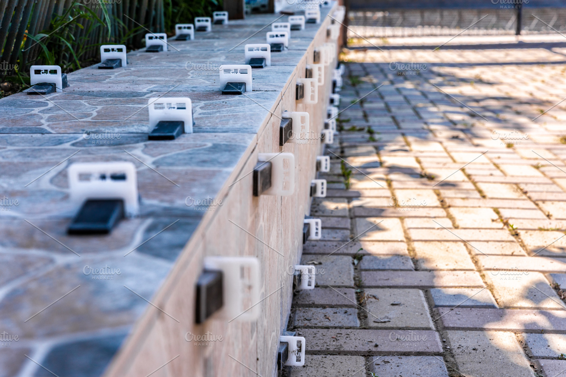 Tile Leveling System on Outdoor Patio, an Architecture Photo by Ales Munt