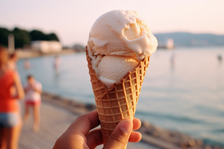 Female hand with holds vanila ice cream on background of a summer beach. The co, a Food & Drink Photo by Natalia Klenova's Shop