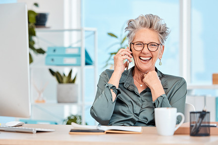 Ceo, business and woman on call with joy about successful startup company plan while feeling cheerful. Laughing, funny and comic communication on a phone call with a mature female executive, a Photo by Peopleimages.com
