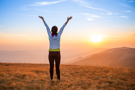 Young woman jumping at sunset mountains, a Person Photo by Vapi