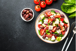 Greek salad in craft plate on black, a Food & Drink Photo by Nadia-nb