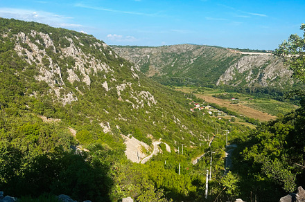 Scenic mountain landscape with rocky terrain under blue sky. Bosnia and Herzego, a Photo by AS photostudio