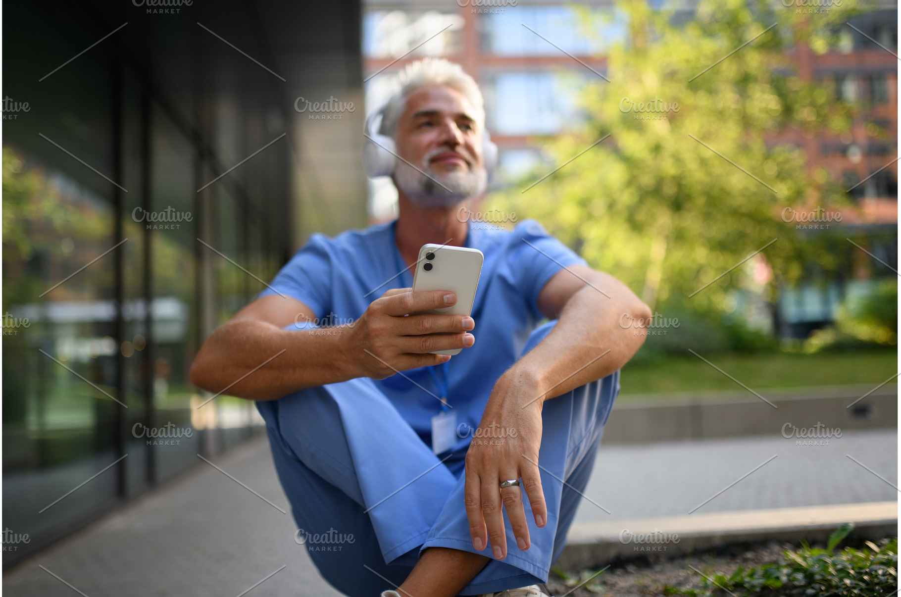 Healthcare worker relaxing with, a Health & Medical Photo by HalfPoint