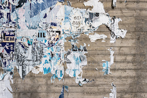 Wall with ripped posters, a Wallpaper Photo by KYNA STUDIO