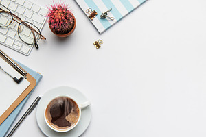Office worker desk with coffee, keyboard, glasses, plant and not, a Business Photo by Olena Rudo