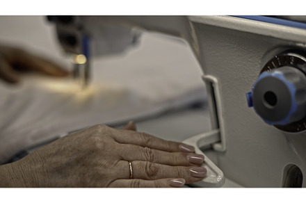 Close up of seamstress sewing white, an Industrial Photo by Media Whale Stock