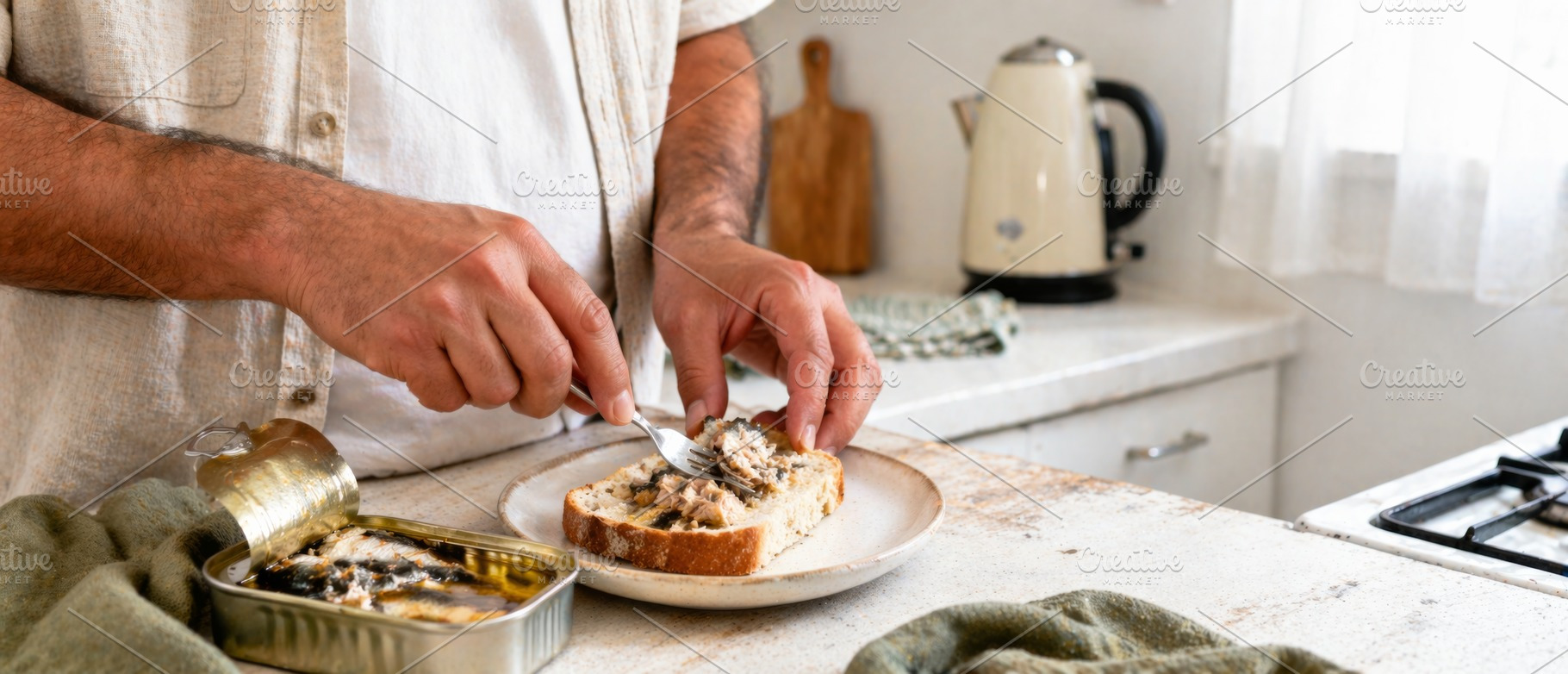 Man preparing sardine sandwich in co, a Photo by Dvoevnore photos