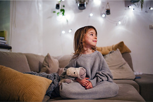 Cute toddler girl sitting on sofa in, a Beauty & Fashion Photo by HalfPoint