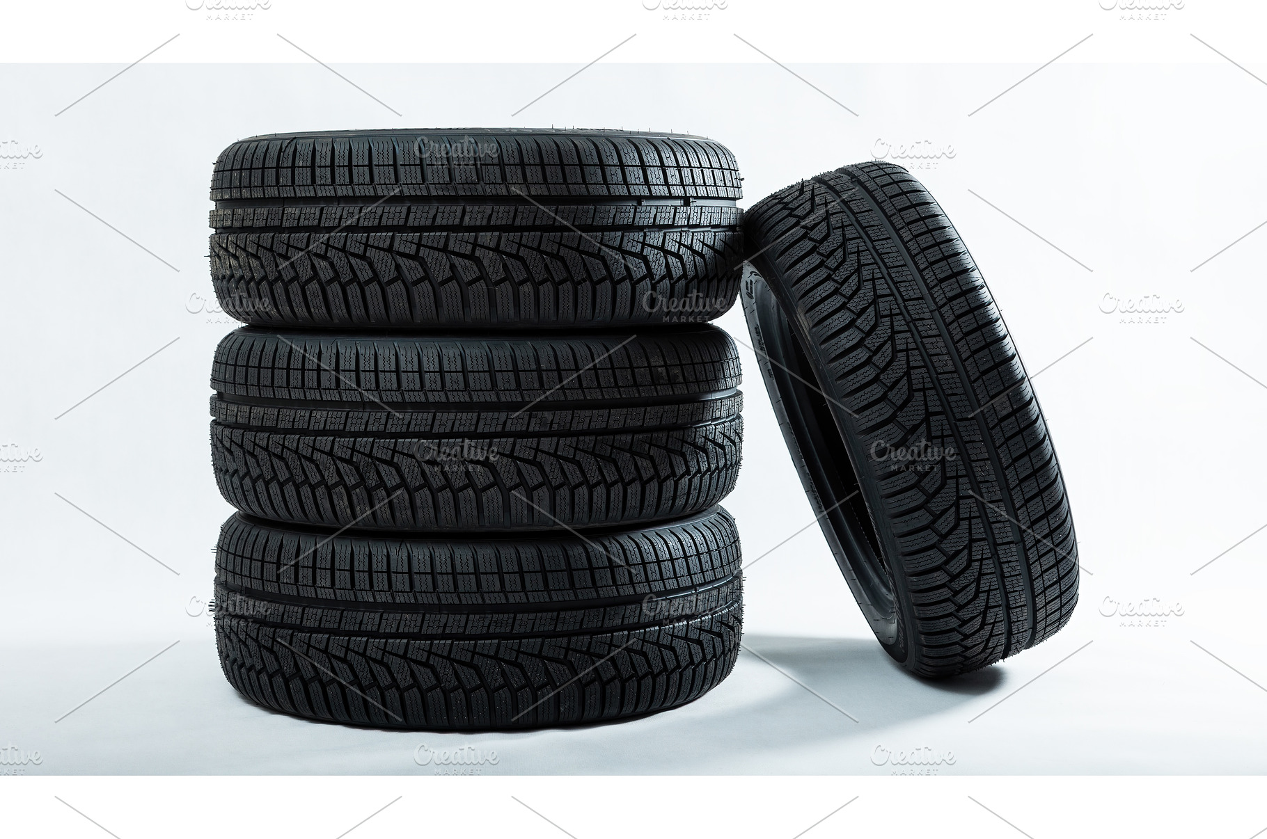Stack of tires with one leaning, a Transportation Photo by WildMedia