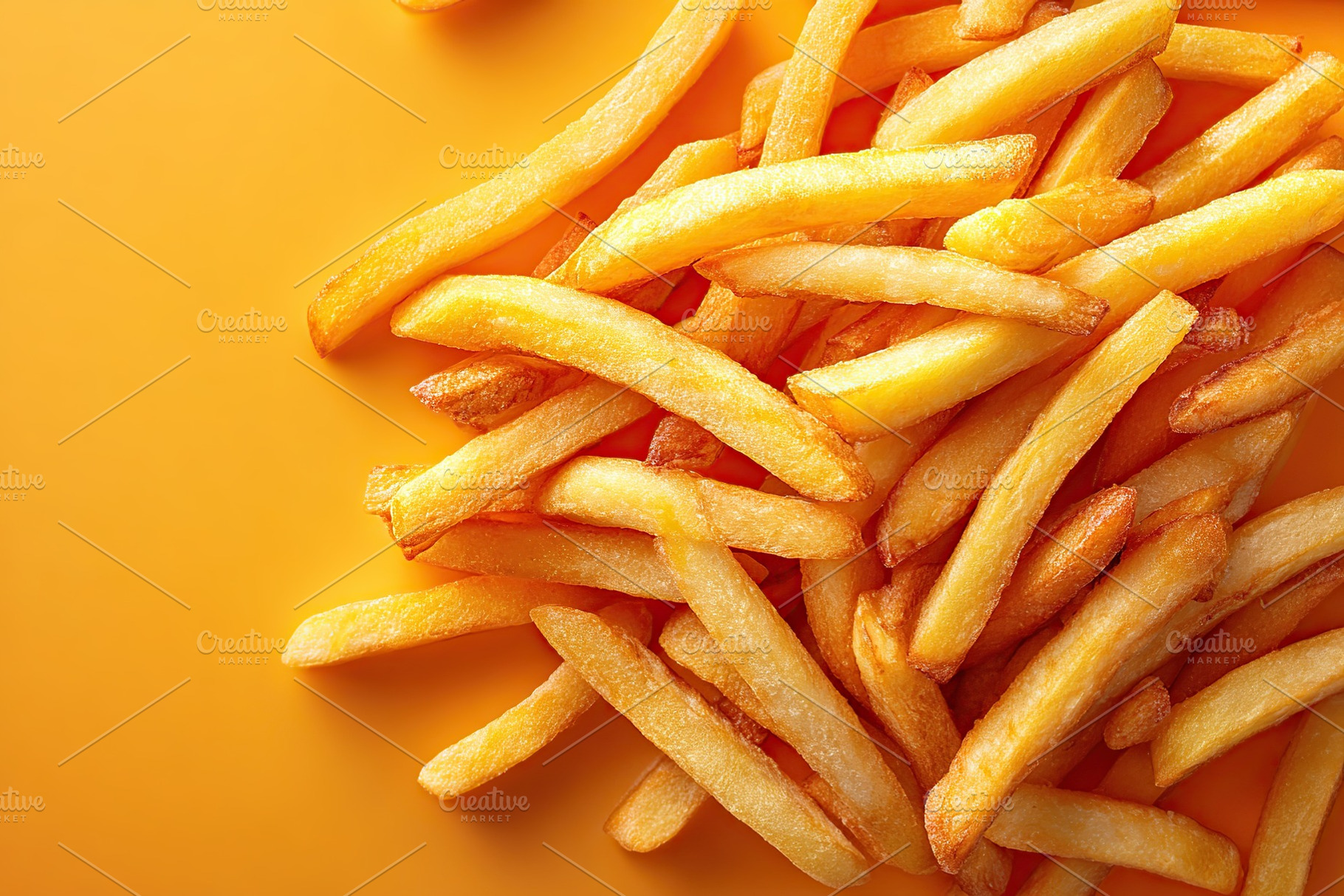 Freshly cooked golden french fries on a vibrant yellow background with crispy t, a Photo by AlyaAnd