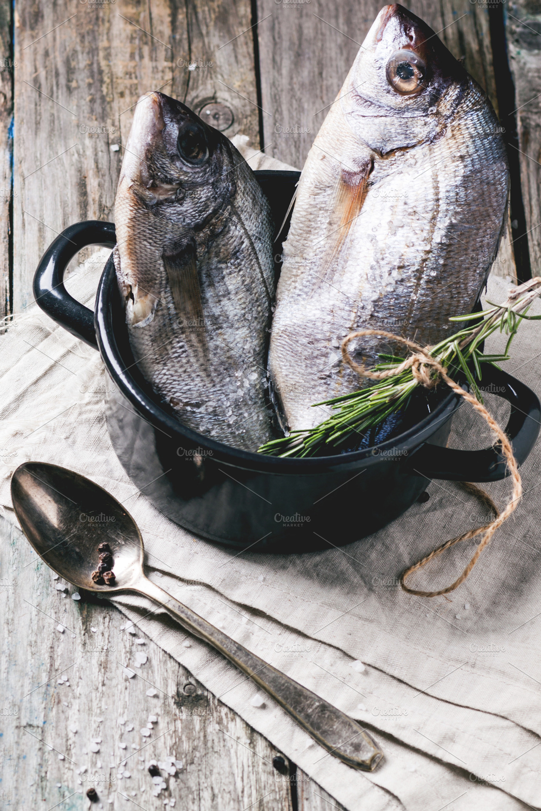 Tow raw dorado fish with rosemary stock photo containing fish and food