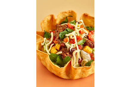 Taco salad in tortilla bowl with