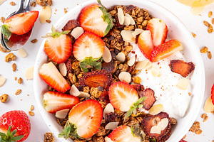 Healthy breakfast bowl with granola, yogurt and strawberry, a Food & Drink Photo by Rimma