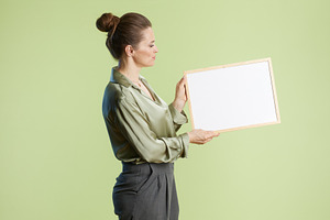 Professional woman with blank whiteboard, a Person Photo by Alliance Images