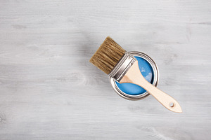 Brush on open can of blue paint