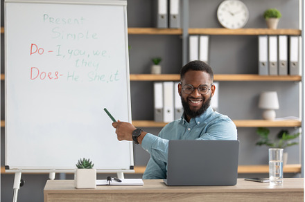 Cheerful young black guy teacher, a School & Education Photo by Prostock-Studio