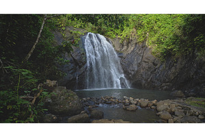 Majestic waterfall cascading into a, a Nature Photo by Goinyk
