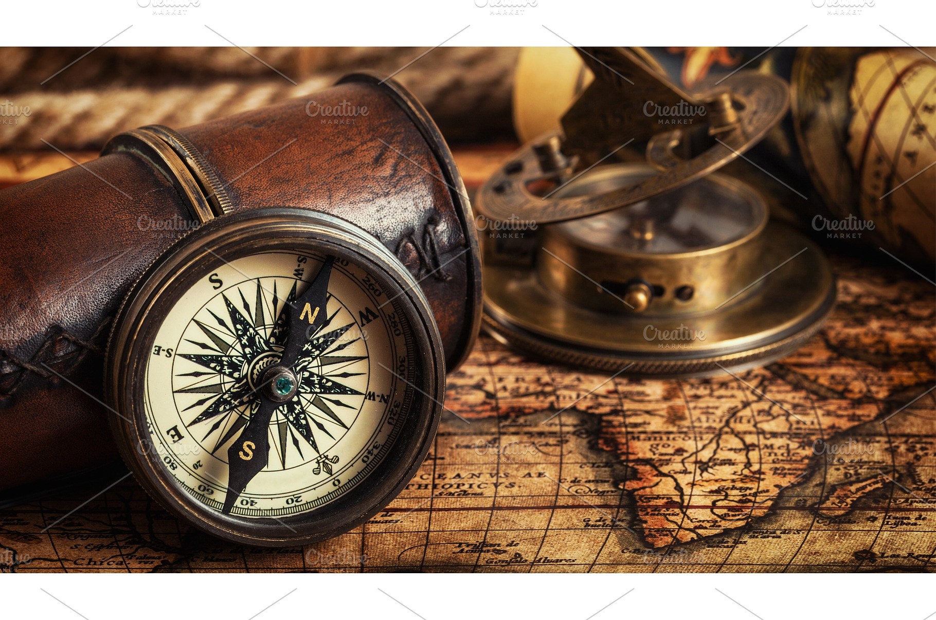Old vintage compass on ancient map, an Arts & Entertainment Photo by f9photos