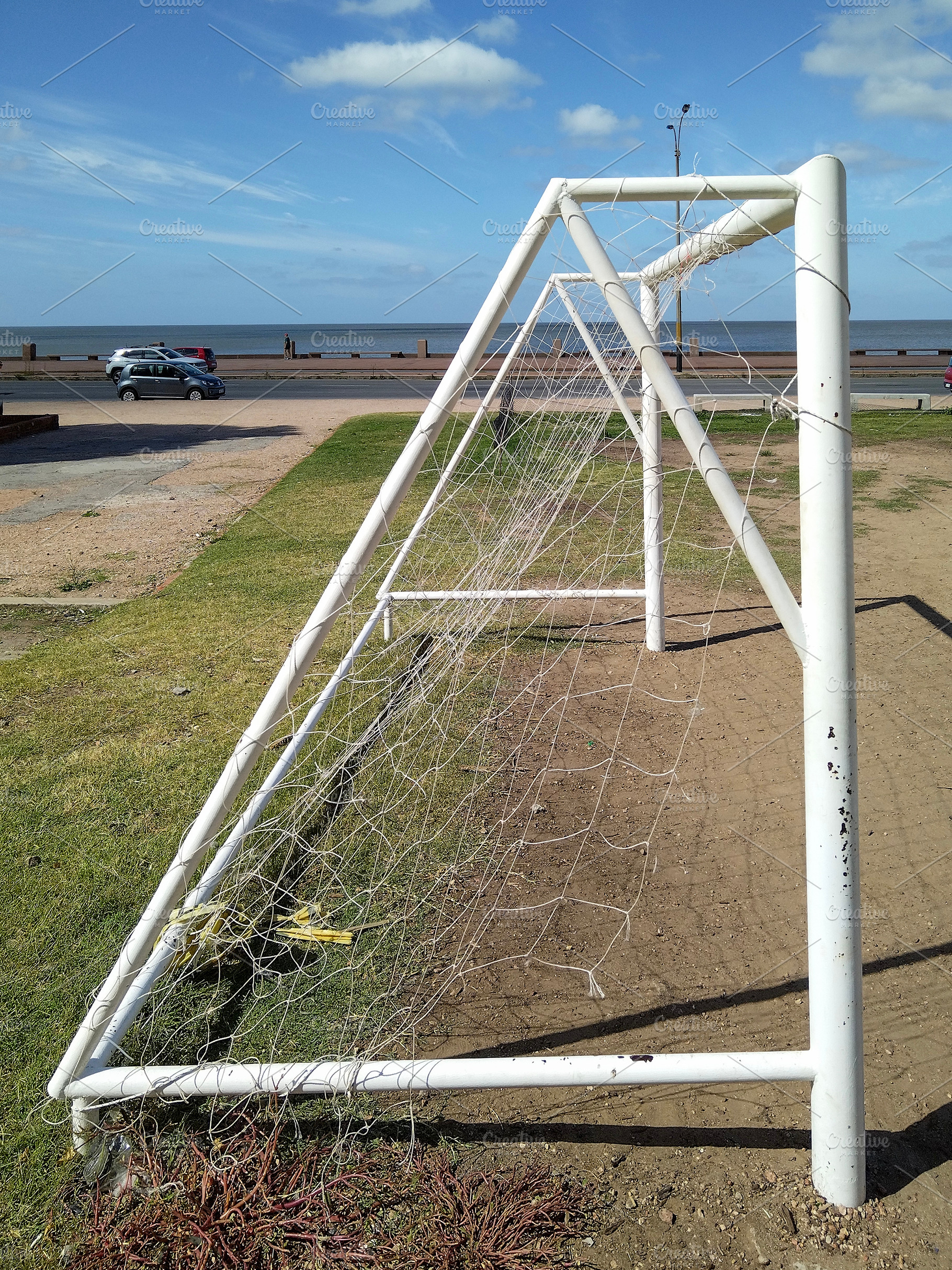 Soccer goal in front of waterfront street, a Sports & Recreation Photo by DanFLCreativo