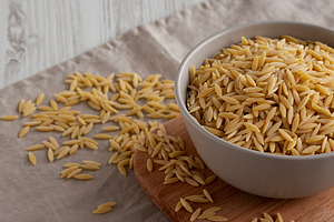 Organic Dried Orzo Pasta in a Bowl, side view., a Food & Drink Photo by LiudmylaChuhunova