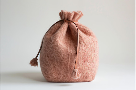 Pink hand knitted wool bag with, a Person Photo by Ylivdesign