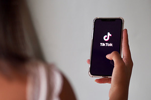 A woman using TikTok app