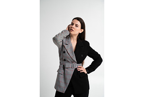 Fashionable woman posing in a studio, a Business Photo by volodymyrshtun13795