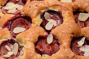 A close-up of a homemade plum pie with plum halves and a sprinkl, a Food & Drink Photo by ndanko