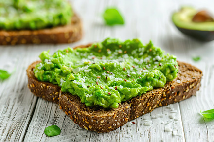 Toast breads with avocado puree on wooden table. Vegetarian food., a Food & Drink Photo by AlyaAnd