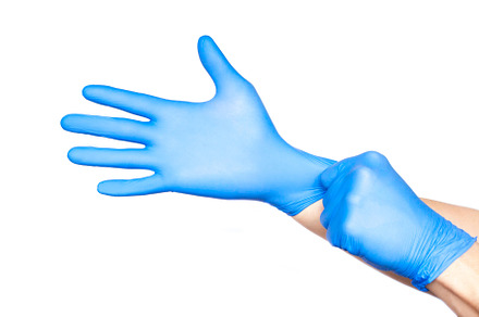 Doctor putting on gloves isolated on containing background, blue, and care