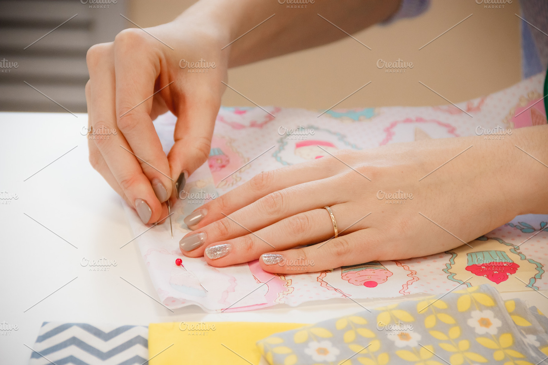 Young seamstress measuring the length with pins, a Person Photo by Maxim Beykov