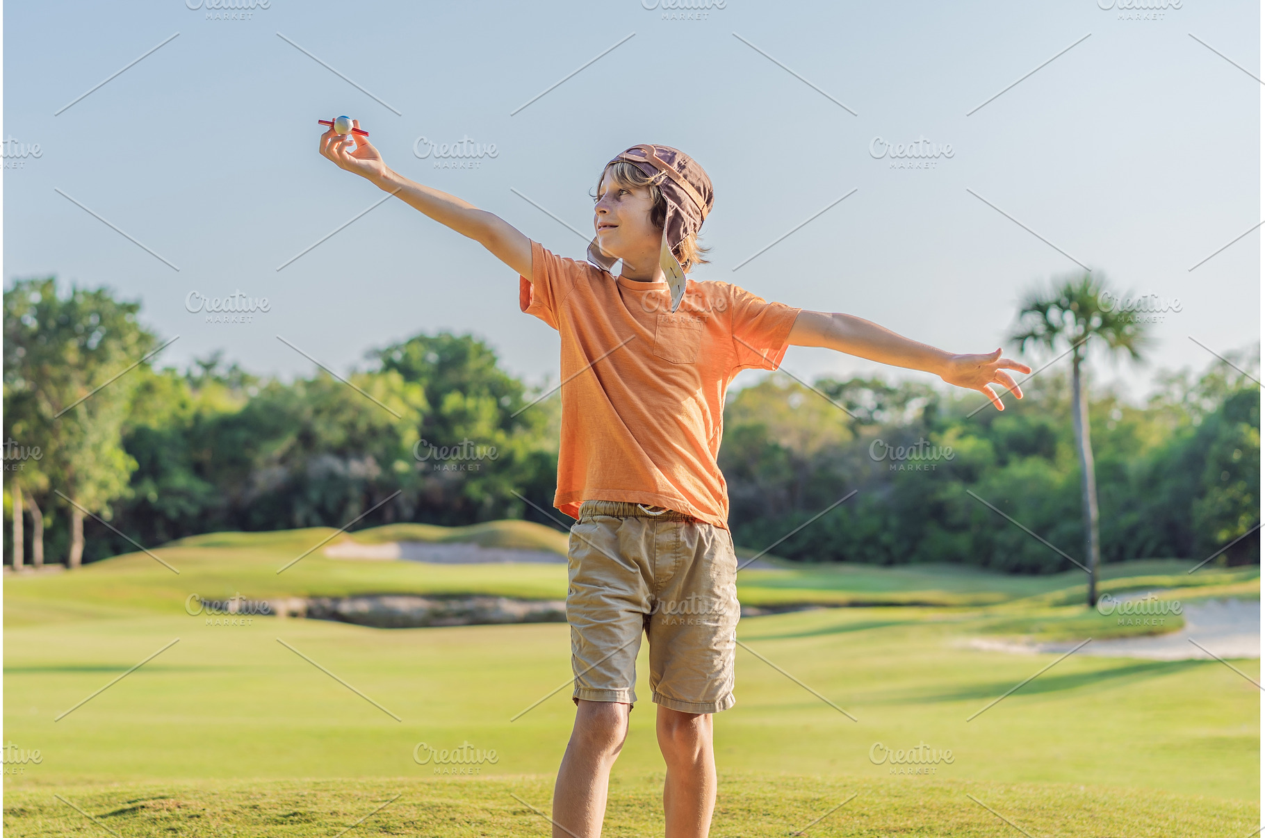 Boy wearing a pilot hat running, a Nature Photo by Elizaveta Galitskaya