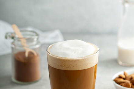Almond milk latte in a glass, a Food & Drink Photo by farwasser