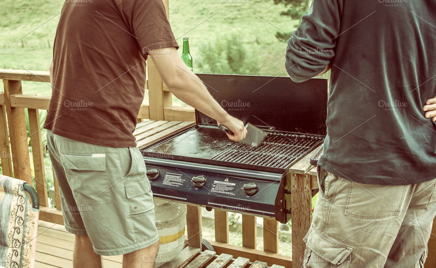 Men Cleaning The Barbecue
