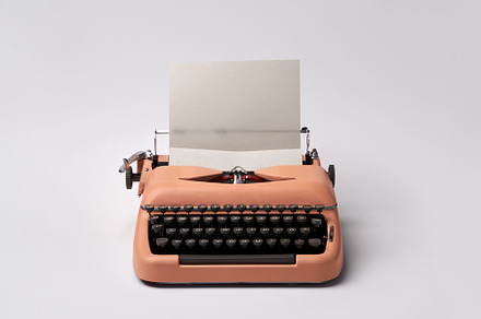 Retro typewriter coral color in stock photo containing typewriter and old