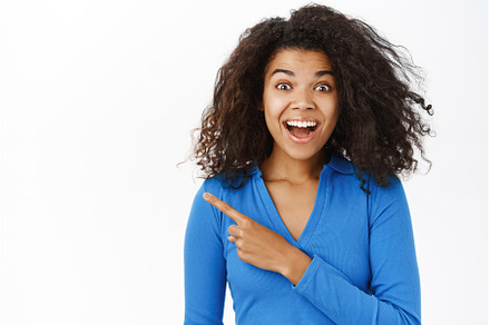 Surprised Black girl, pointing left