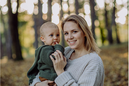 Mother holding her little baby son, a Nature Photo by HalfPoint