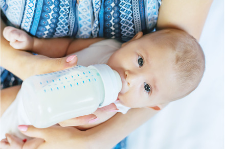Mom feeds the baby with a bottle, a Person Photo by yanadjana