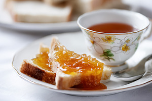 Slices of fresh white bread spread with golden marmalade and a d, a Photo by Studio ANNA