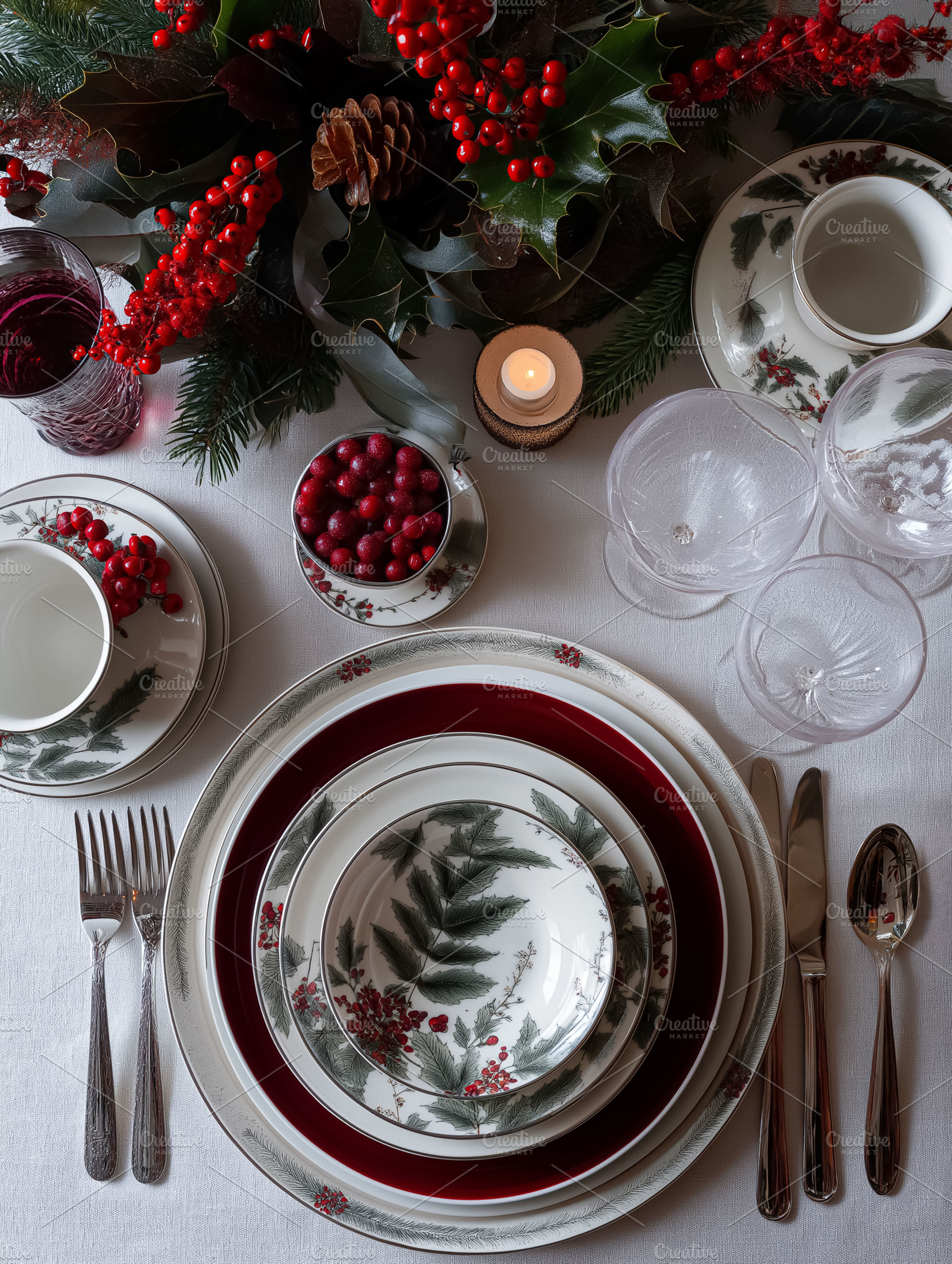 Elegant festive table setting with fine china, holly, berries, candles, and win, a Food & Drink Photo by Studio ANNA