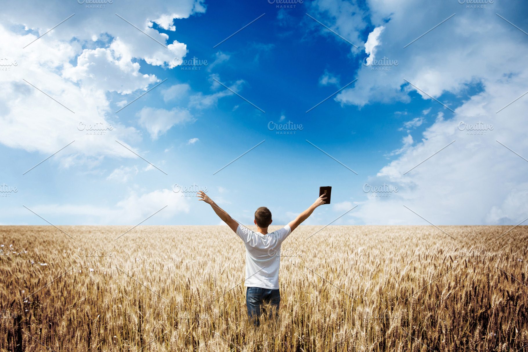 Man holding up Bible in a wheat fiel, a Person Photo by 5max