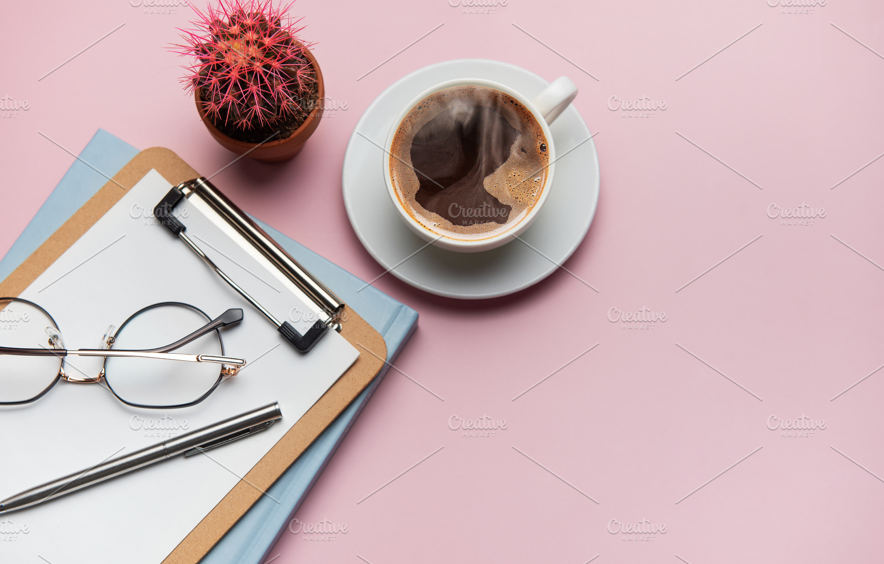Coffee break accessories arranging on pink table with cactus pla, a Business Photo by Olena Rudo