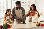 Cheerful Black Family Cooking Making Vegetable Salad In Modern Kitchen, a Photo by Prostock-Studio (Thumbnail 1 of 2)