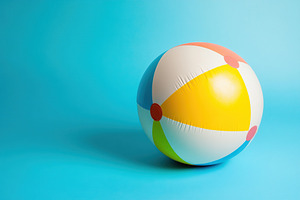 Bright beach ball resting on a pastel blue background perfect for summer activi, a Photo by AlyaAnd