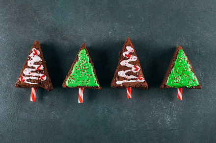 Christmas tree made from chocolate biscuit cake brownie on stone background. Ho, a Holiday Photo by Anikona