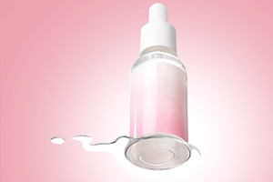Pink Cosmetic Serum Bottle with Spilled Liquid, a Beauty & Fashion Photo by vimart