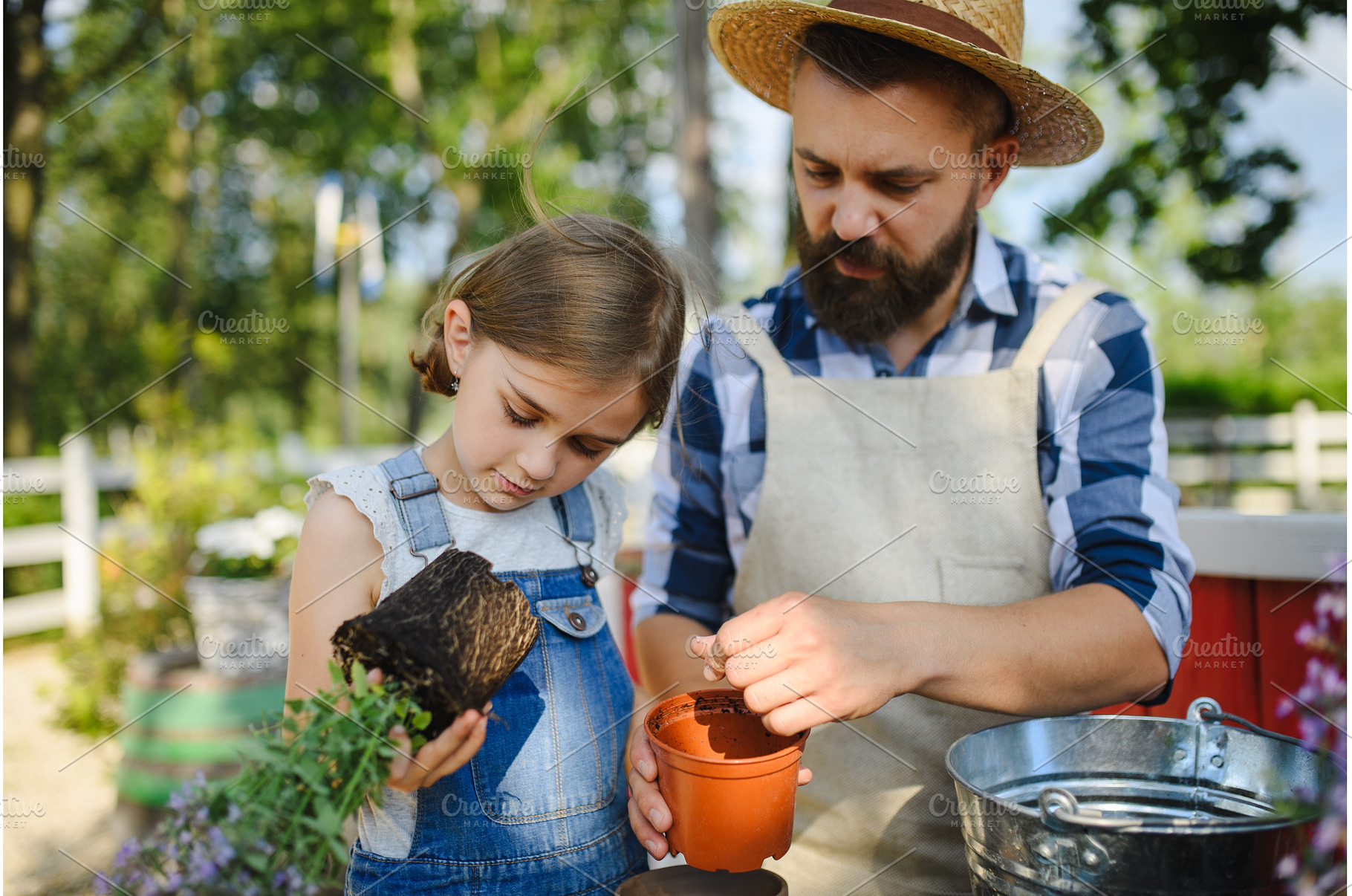 Father and young daughter planting, a Nature Photo by HalfPoint