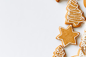 Christmas cookies with stars snowflakes and trees on white backg