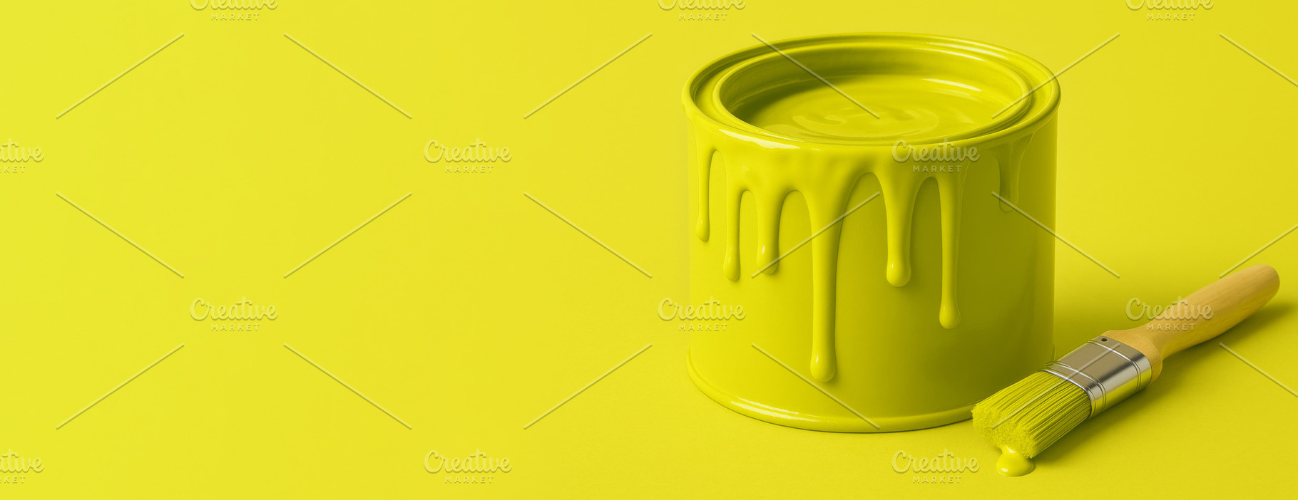 Chartreuse paint can with dripping lime color and brush on solid, a Photo by Dvoevnore photos