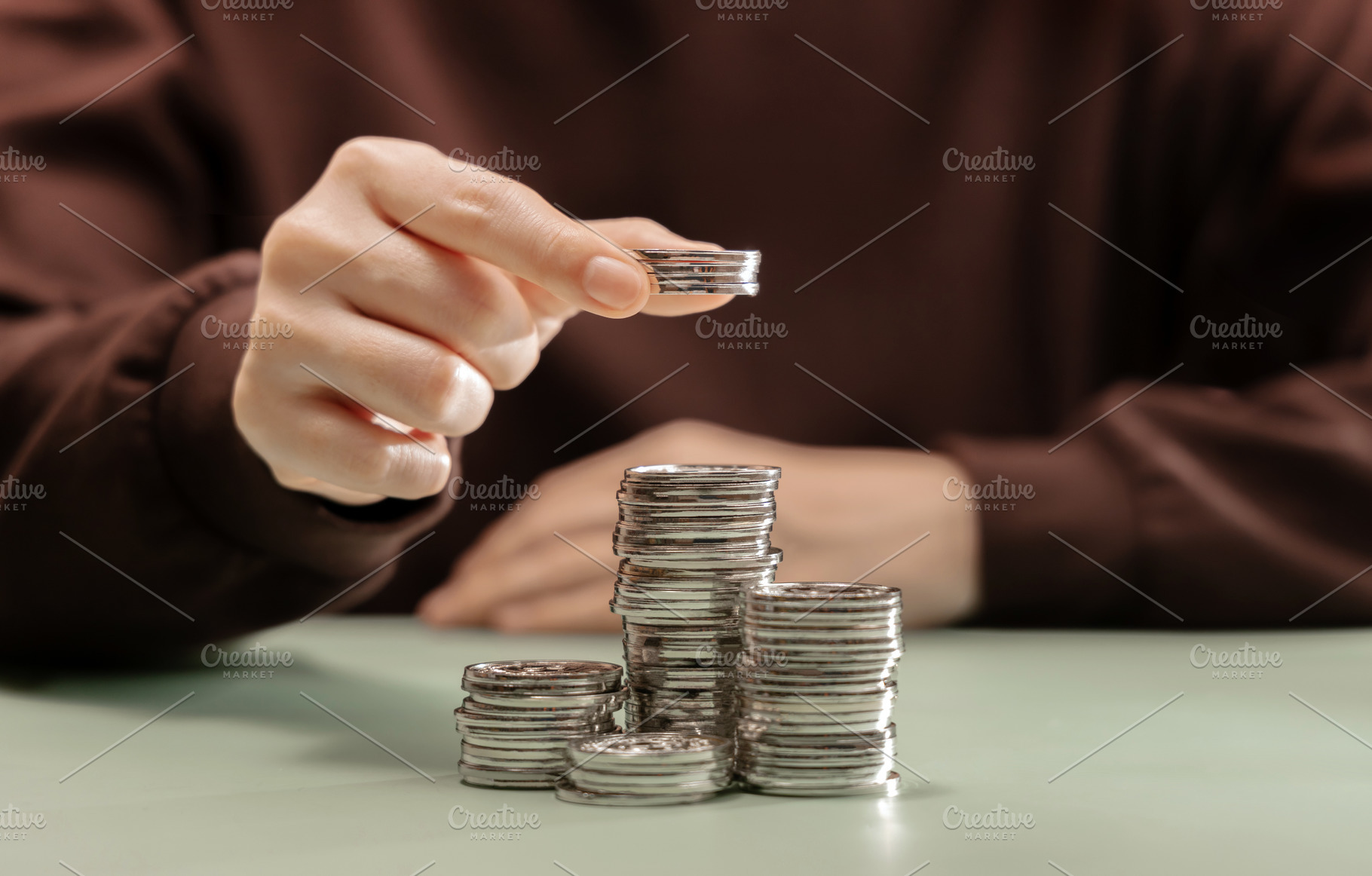 Growing stack of coins representing saving money, financial grow, a Photo by salmon.black